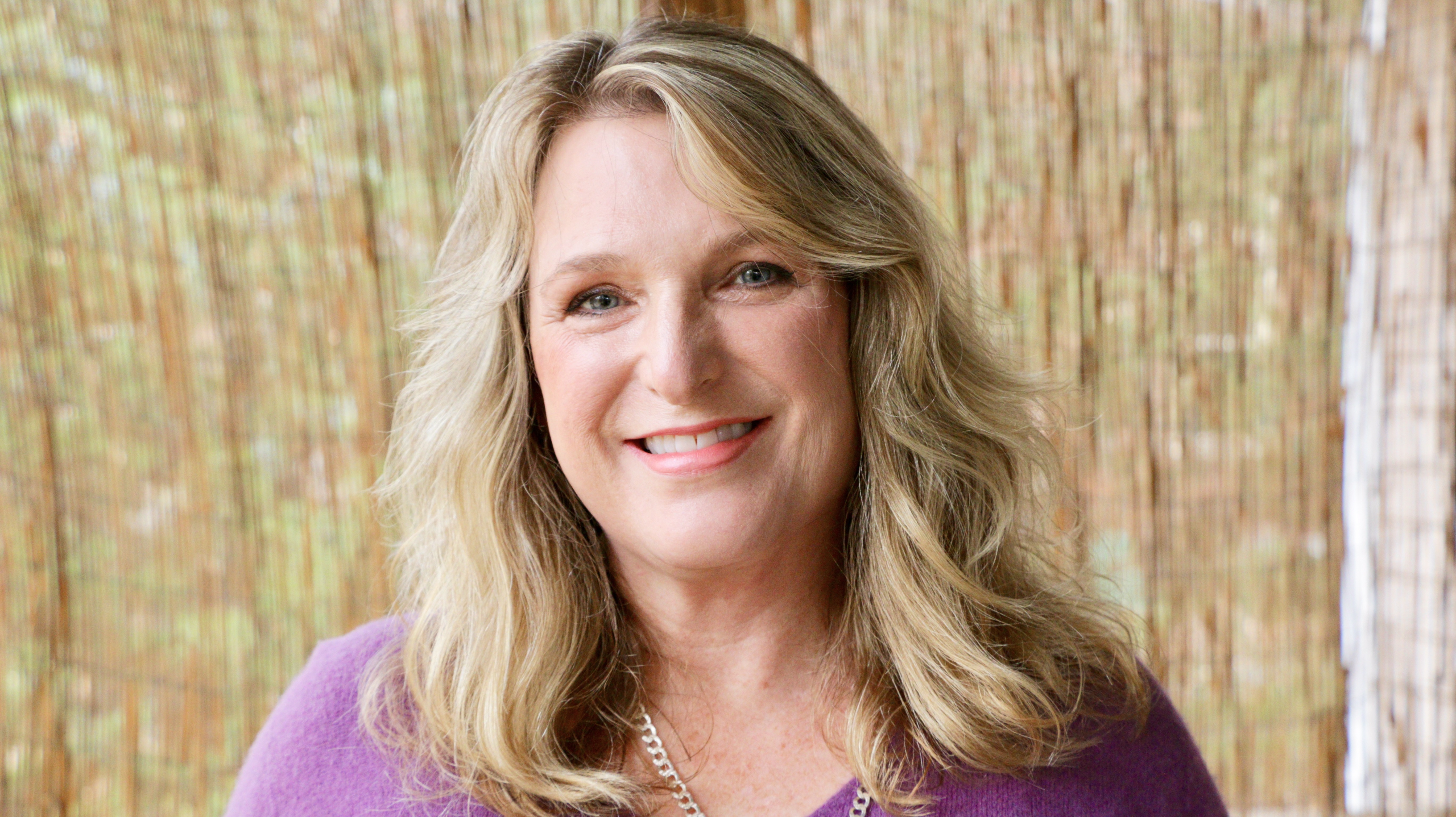 Janet Haas, Clinical EFT Practitioner and nervous system regulation expert in Charlotte, NC, smiling for Rising Feminine EFT