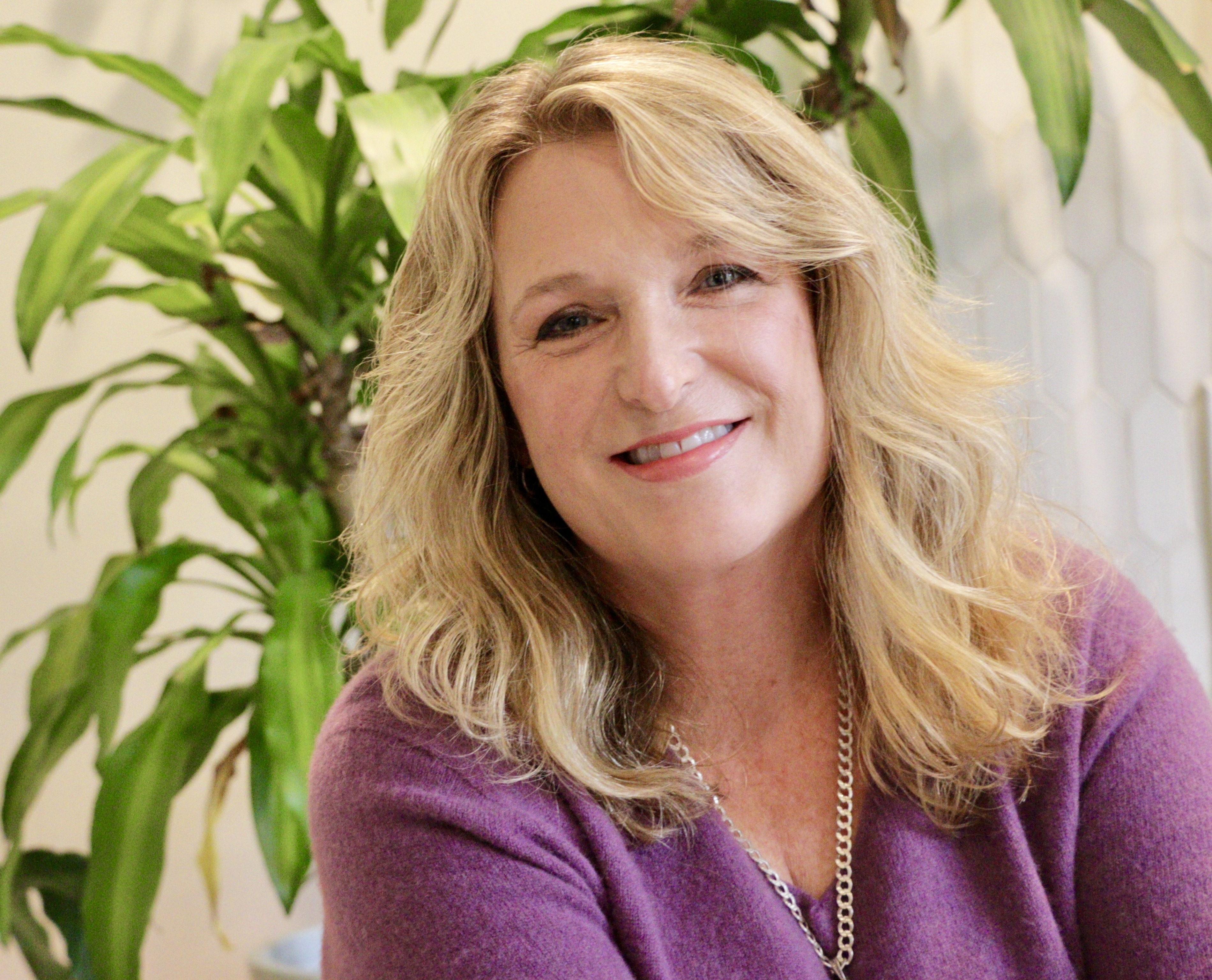 Janet Haas, Clinical EFT Practitioner in Charlotte NC, a nervous system regulation expert, smiling for Rising Feminine EFT